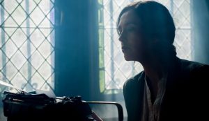 writer writing on type writer