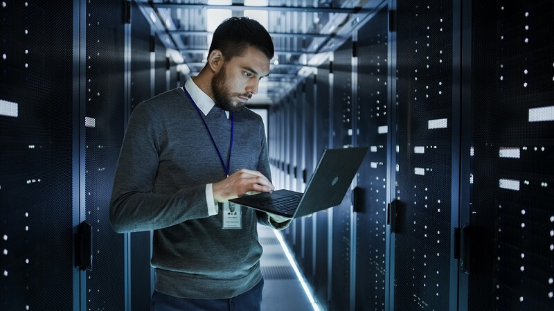 man checking on laptop if servers are working fine