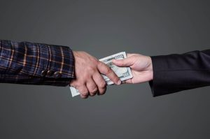 man giving money to other man