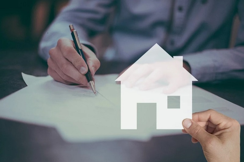 man hand holding paper house and other man signature on the paper