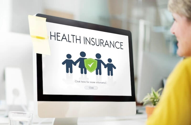 health insurance on screen in front of woman