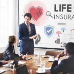 people in meeting and life insurance on board