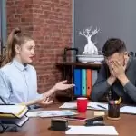 man anxitey of workplace and near sit a girl in chair