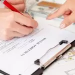 person signs the rental agreement