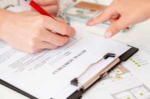 person signs the rental agreement