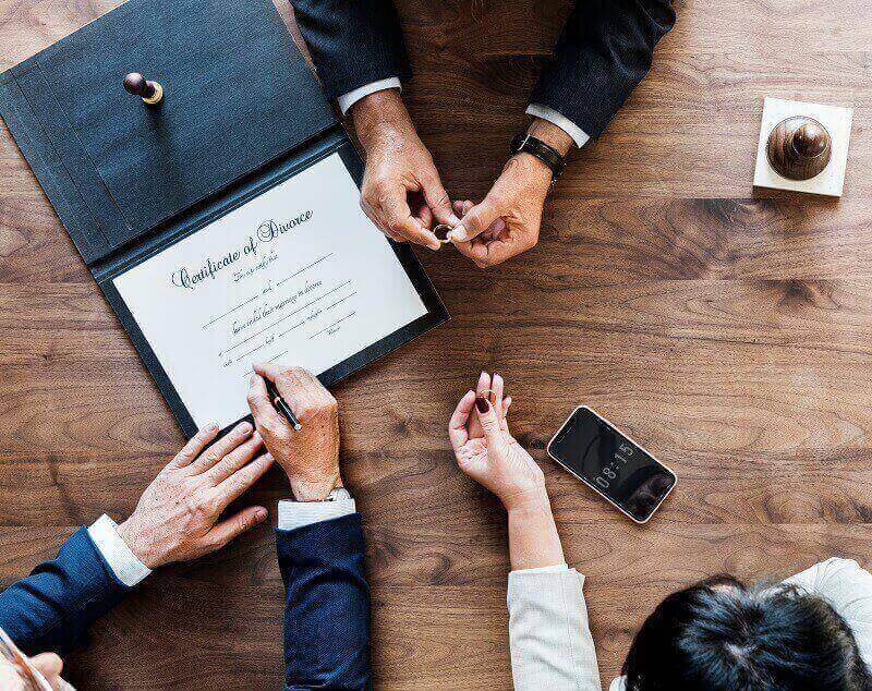 couple sign the divorce certificate with lawyer