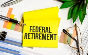 federal retirement written on the yellow paper with other things on the table